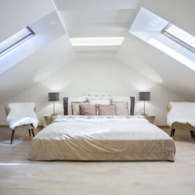Bright attic bedroom in the fashionable apartment